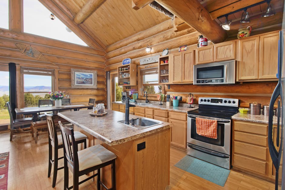 Warm and inviting log cabin kitchen showcasing rustic wooden interior and modern amenities.