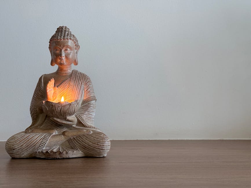 A calming Buddha statue with glowing candlelight, ideal for meditation settings.
