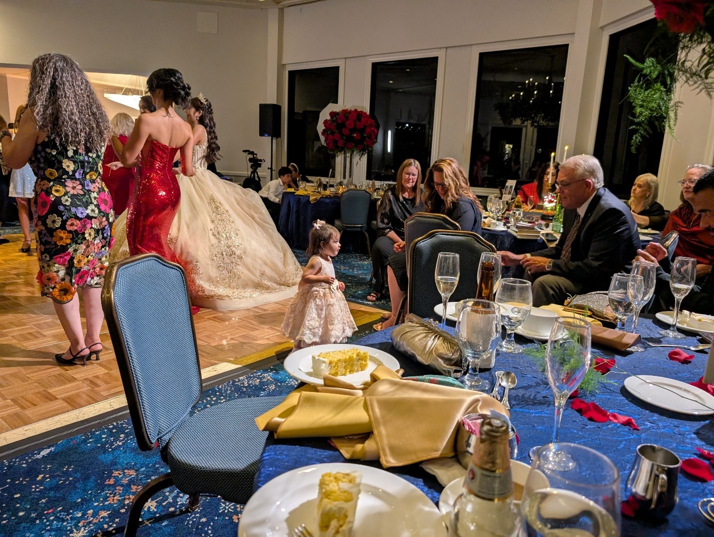 Children at decorated party tables during the quinceañera.