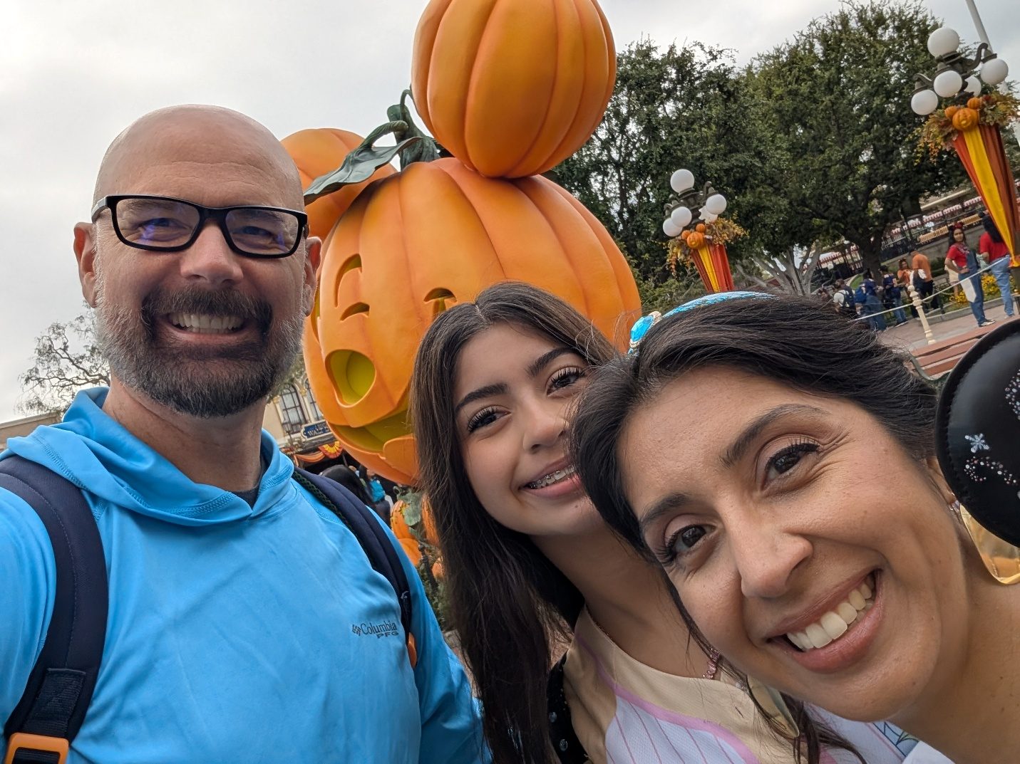 Family selfie with Halloween pumpkins in the park.