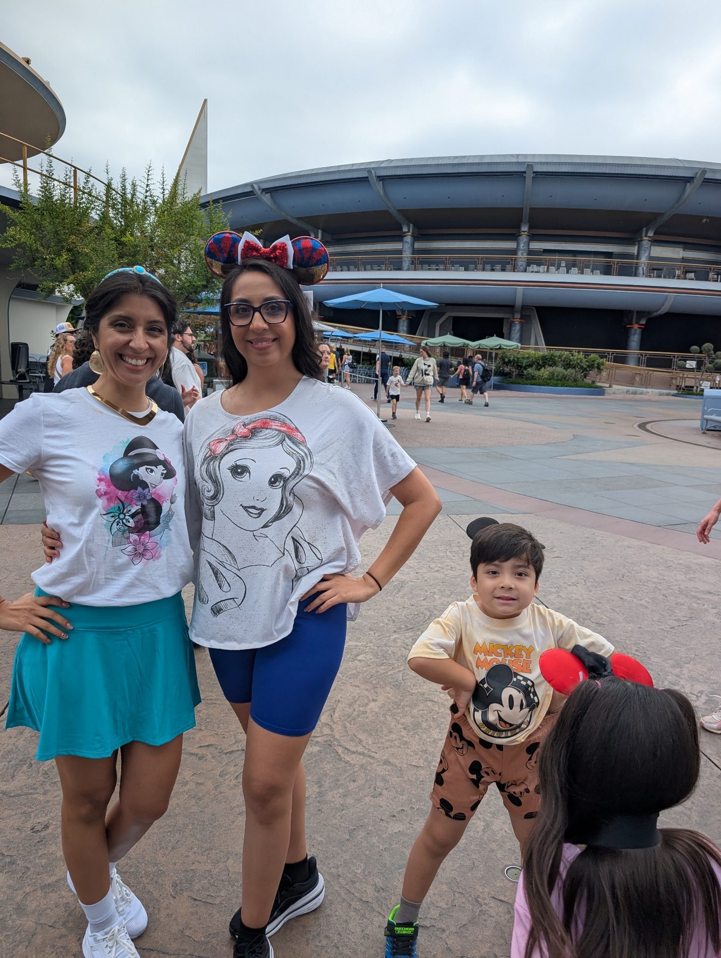 Family members standing near Disneyland’s Tomorrowland entrance.