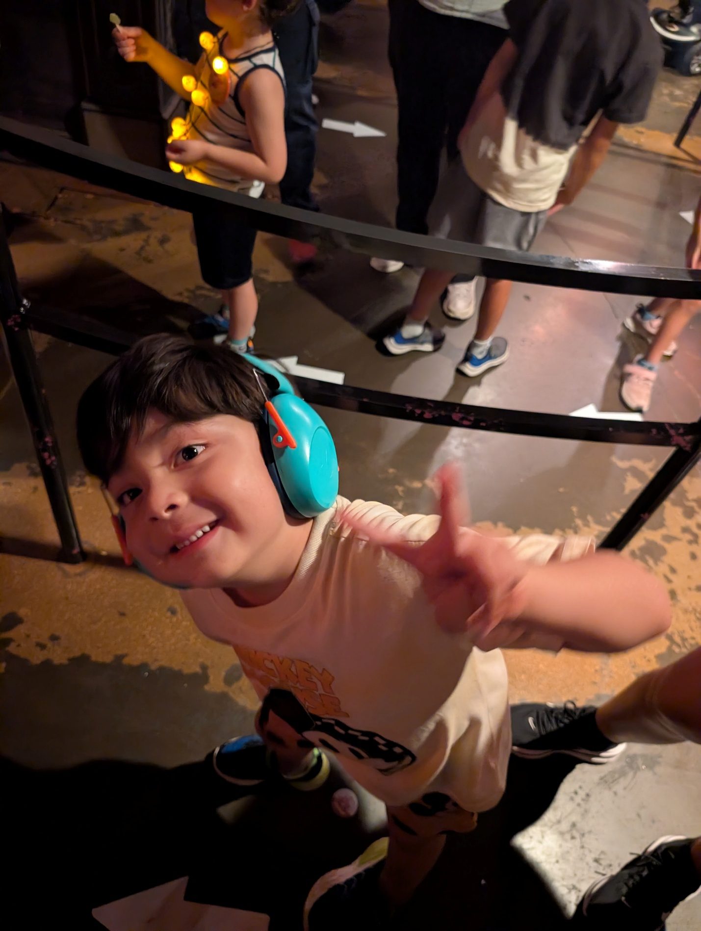 Child reaching up from a ride vehicle.