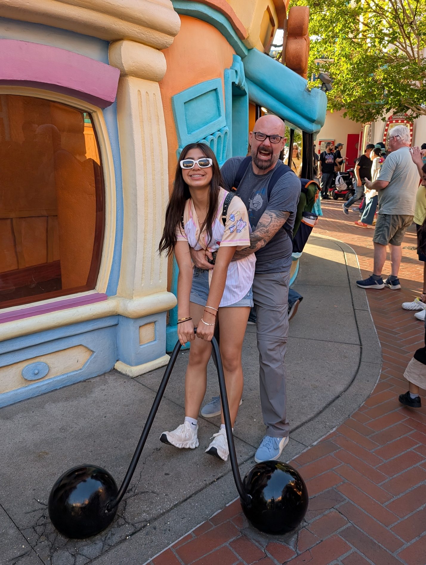 Family posing in a Toontown vehicle display.