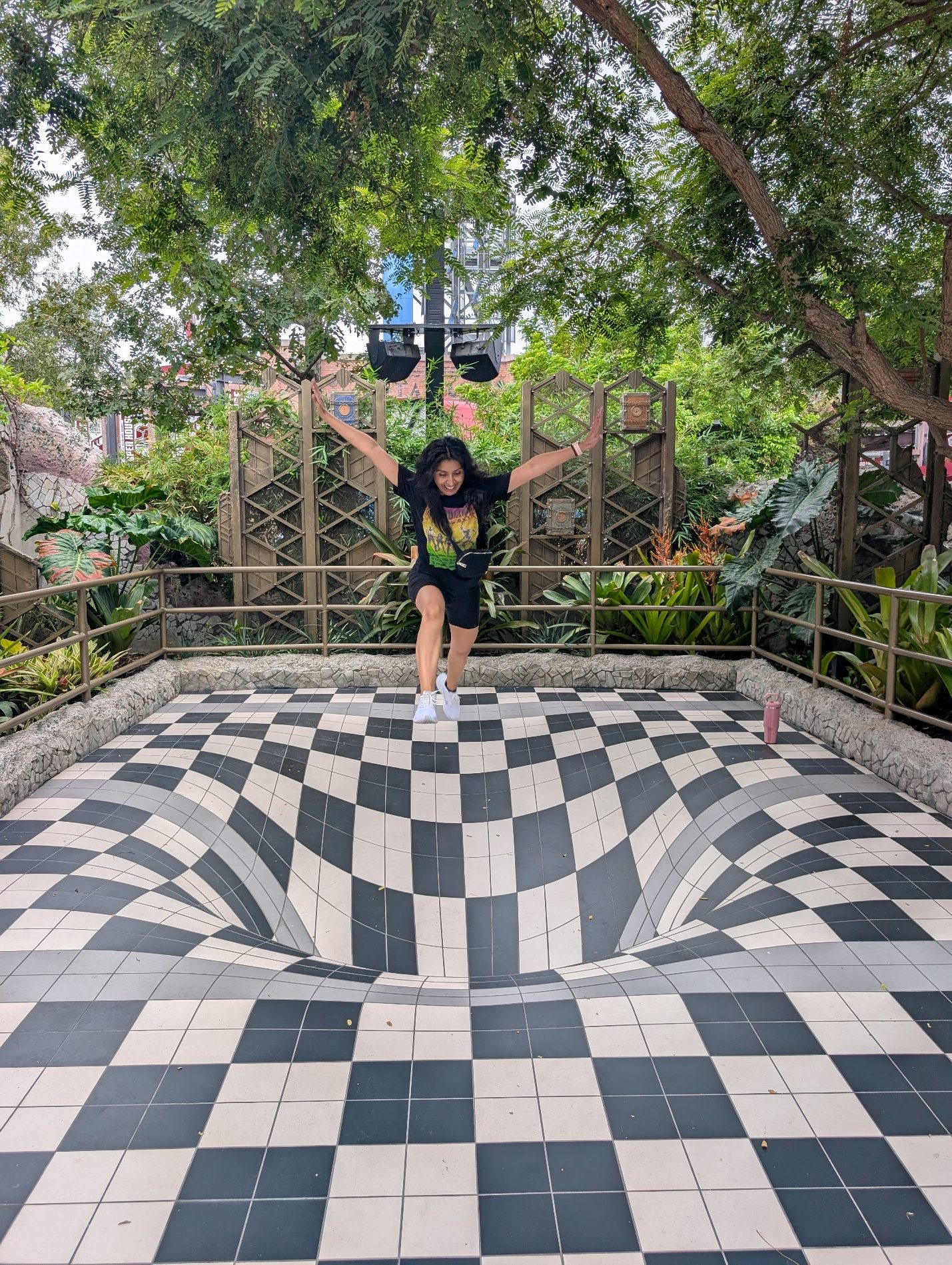 Guest standing on a black and white checkerboard walkway.