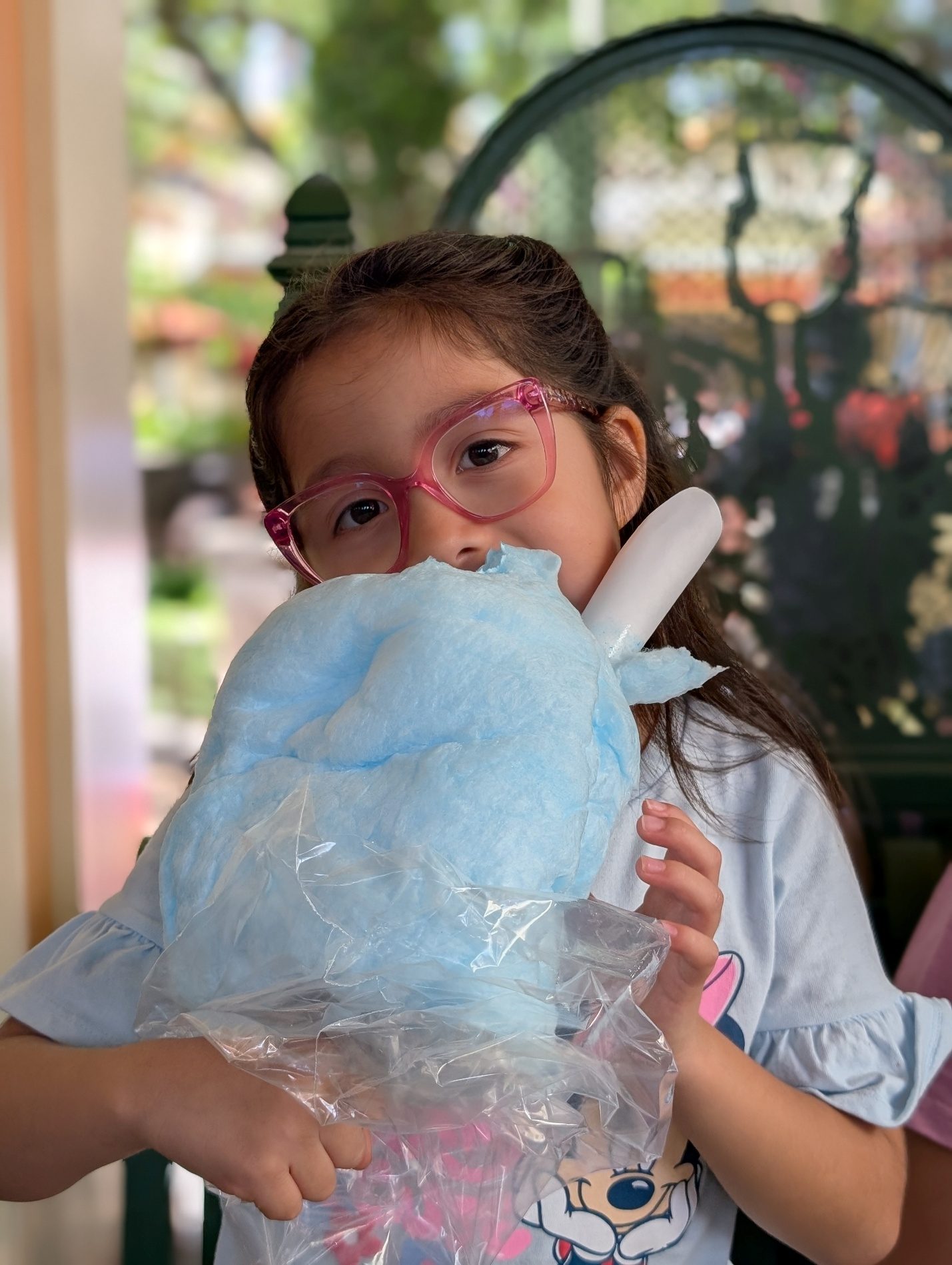 Child eating cotton candy.