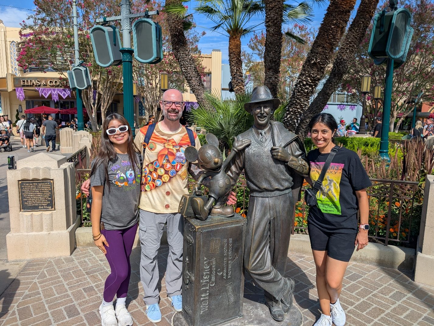 Family posing with the Walt Disney and Mickey statue.