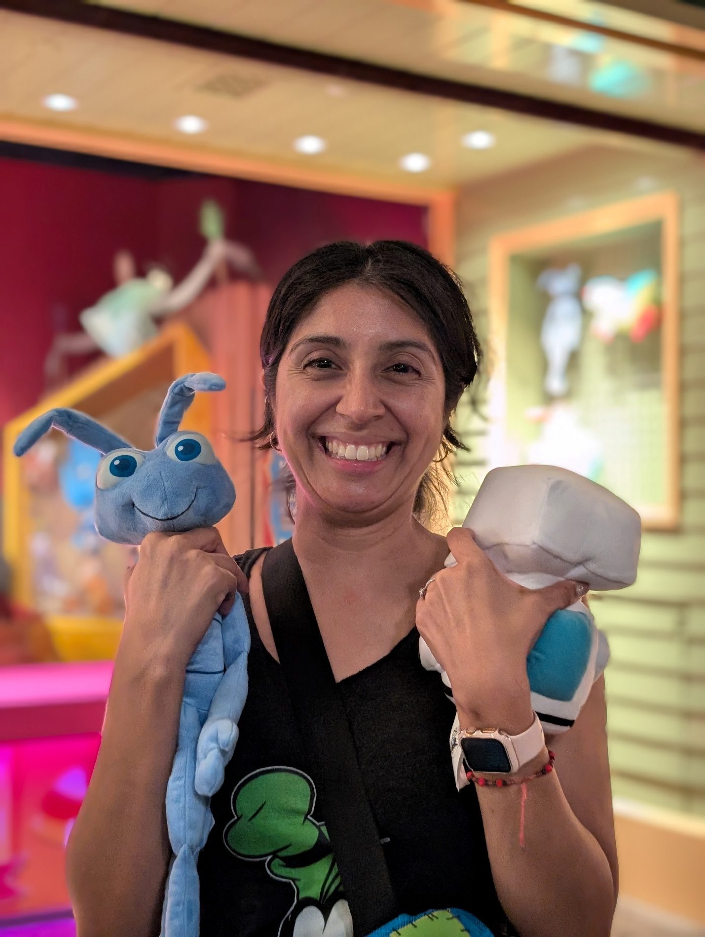 Guest holding Disney plush toys.
