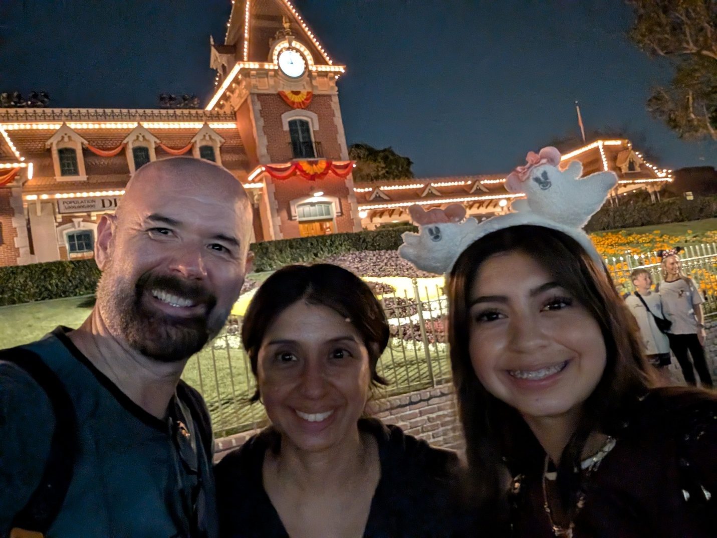 Family selfie on Main Street at night.