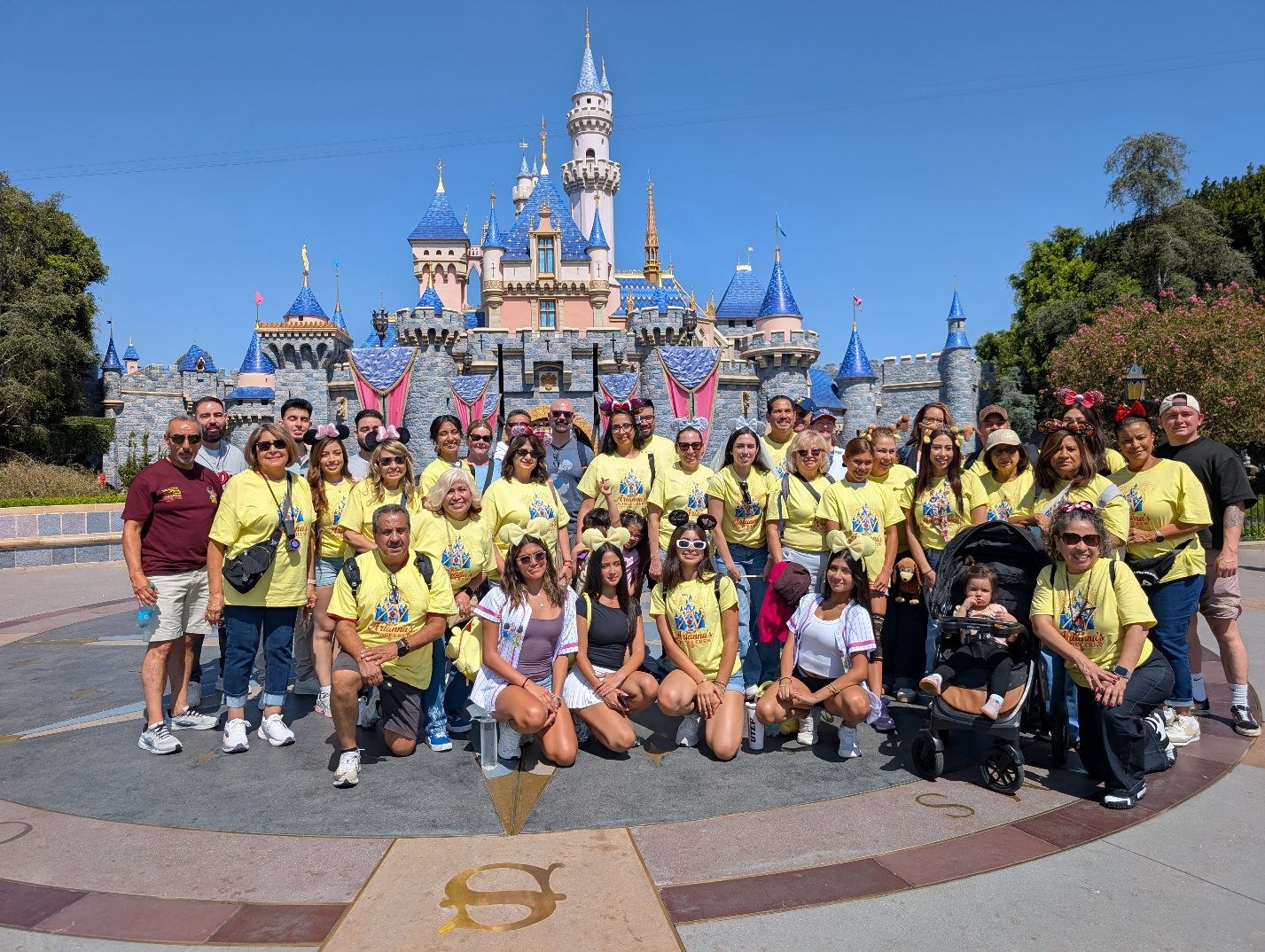 Large family group photo in front of Sleeping Beauty Castle.